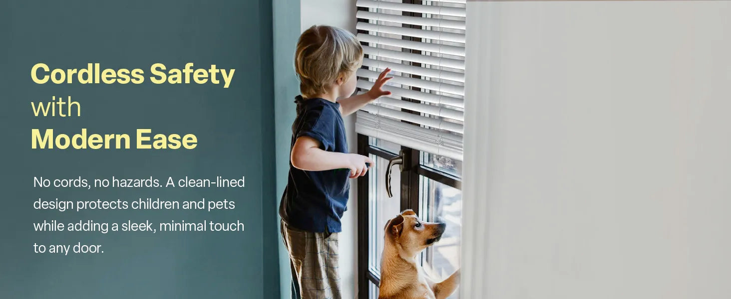 A lifestyle image titled "Cordless Safety with Modern Ease" showing a young child and a dog looking out a glass door fitted with white blinds. The accompanying text emphasizes a "clean-lined design" with "no cords, no hazards" to protect children and pets while adding a minimal touch to any door.