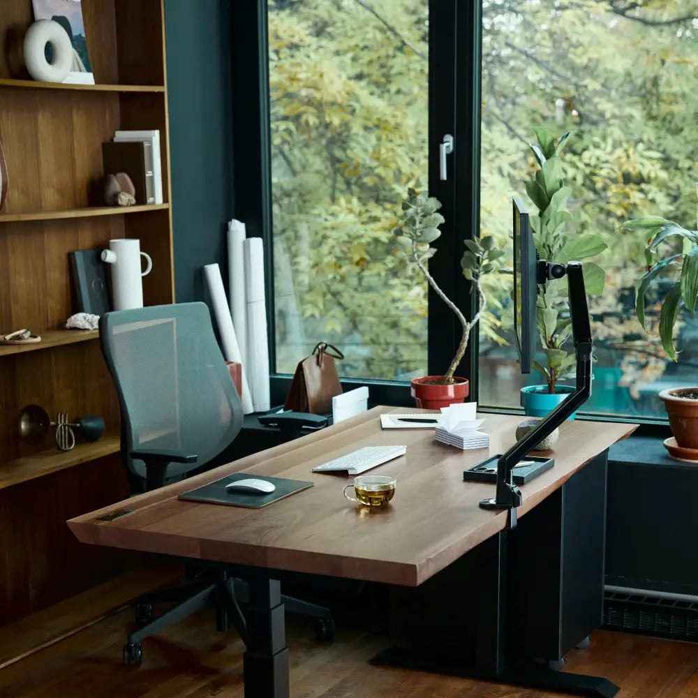 Modern home office with large window highlighting need for blinds or shades to reduce glare and improve light control