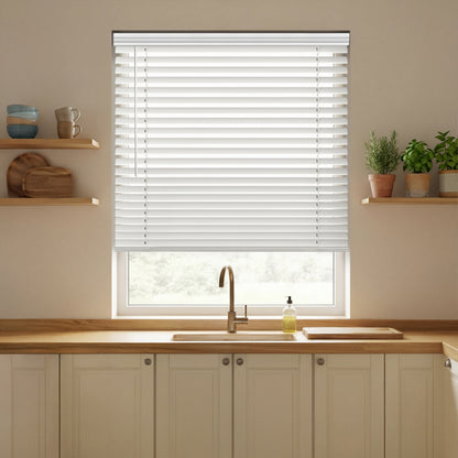 Kitchen with wooden countertops, a sink, and a window with white faux wood blinds.